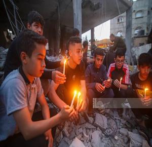 Palestinian children in the Gaza Strip light candles on the rubble of their houses in Rafah.