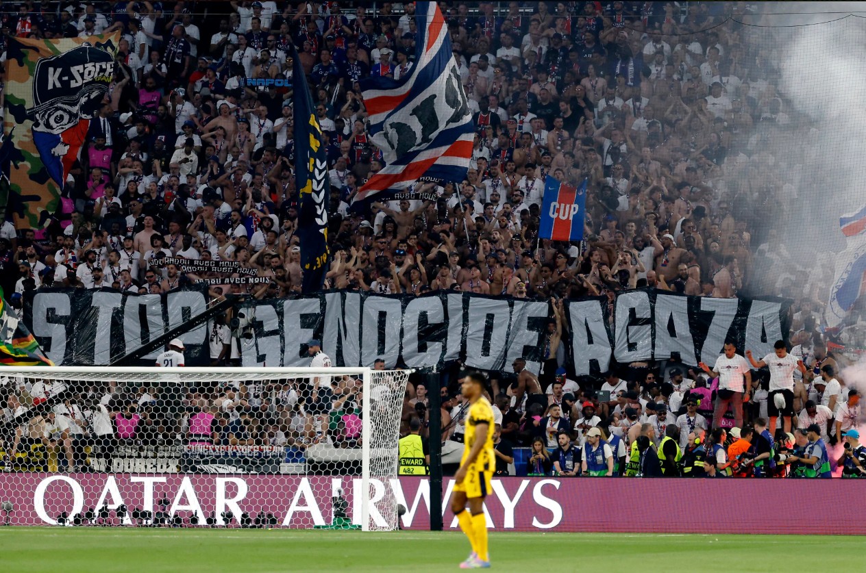 Fans hold a massive banner reading "Stop genocide in Gaza" during the UEFA Champions League final soccer match between Paris Saint-Germain (PSG) and Inter Milan in Munich, Germany, May 31, 2025. (Odd Andersen / AFP)