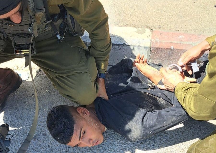 Israeli soldiers assault, detain a young man in Huwara