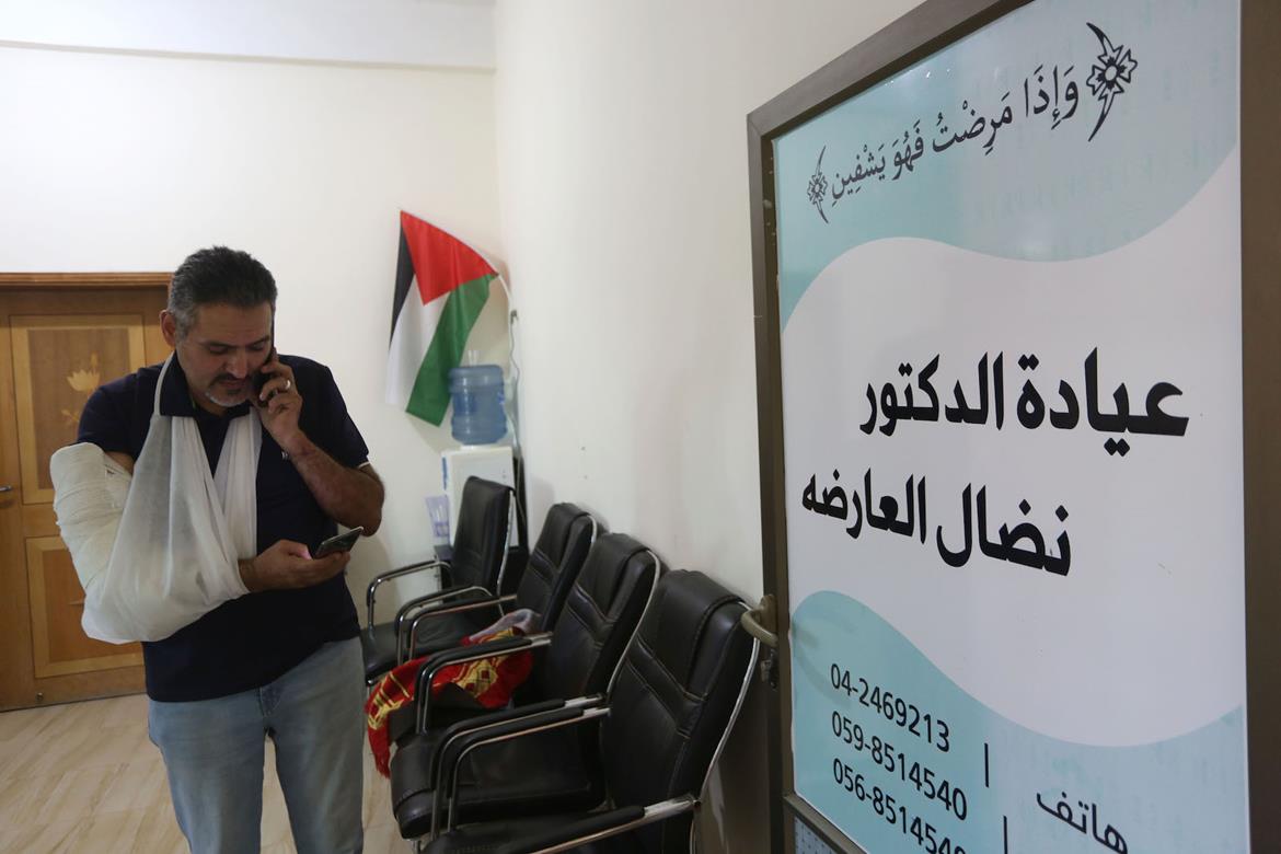 Physician says soldiers treated him with sedatives for his arm broken when an Israeli soldier pushed him