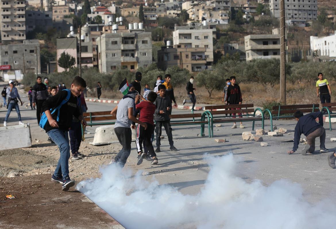 Israeli army's firing of tear gas canisters into schoolyard in Hebron causes students and teachers to suffocate, faint 