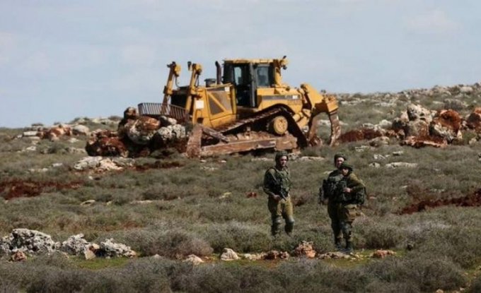 Palestinians in a northern West Bank village prevented by Israeli soldiers from working on their lands