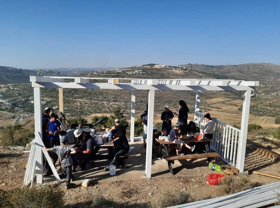 Settlers rebuild an outpost near the village of Luban e-Sharkiya
