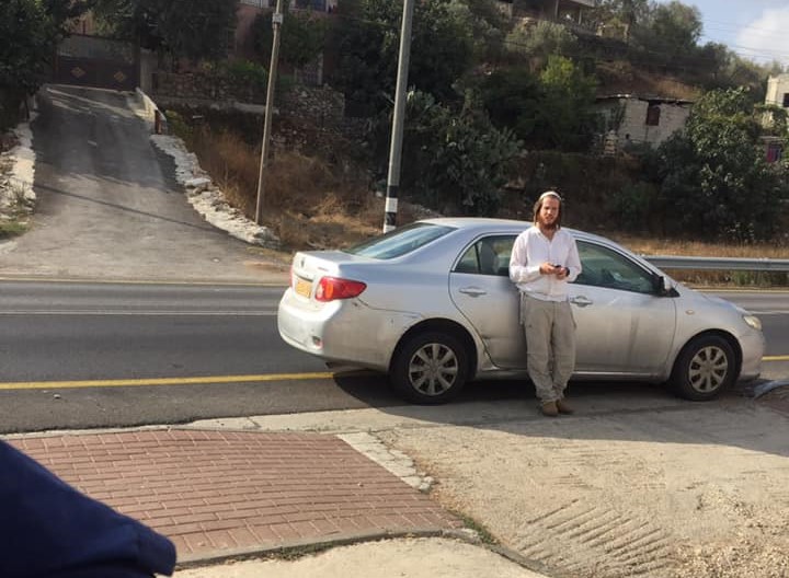 An Israeli settler, soldiers harass Palestinian students at a 
West Bank girls school