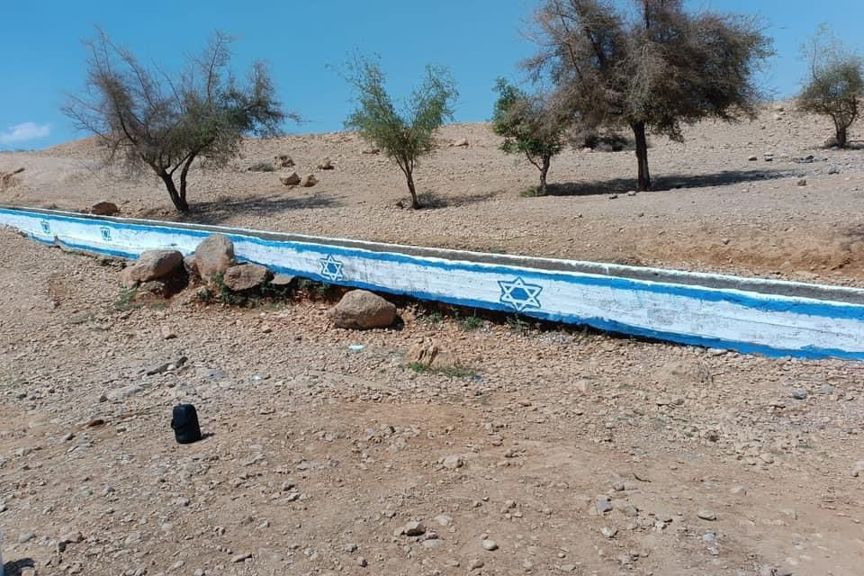Israeli colonists spray-paint occupation flag on water spring near Jericho