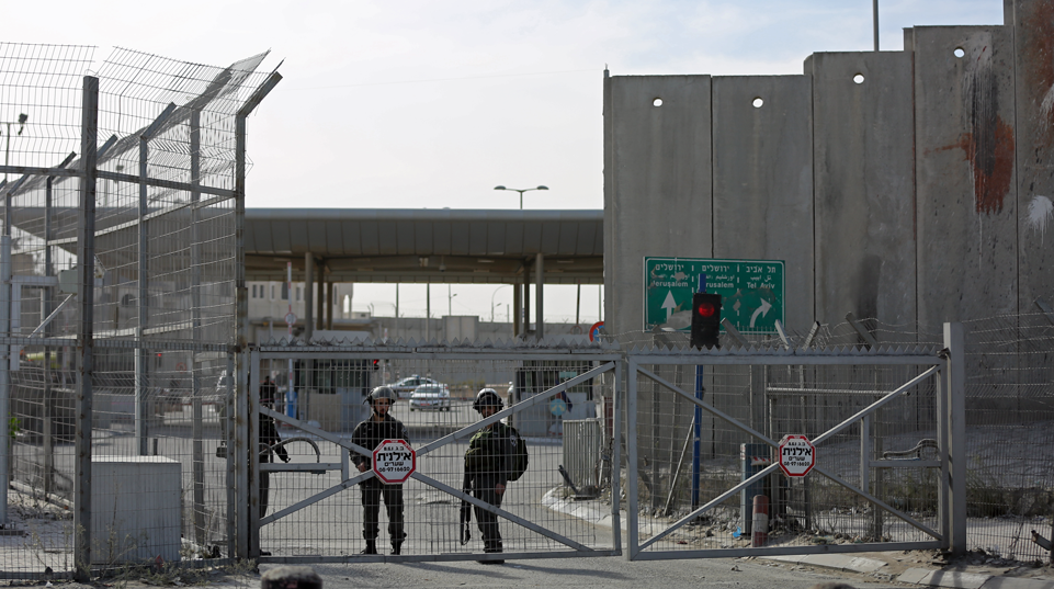 Palestinian woman subdued at Qalandia checkpoint near Jerusalem among 16 Palestinians detained by Israel