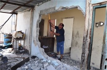 A Palestinian resident of occupied East Jerusalem forced to demolish own house