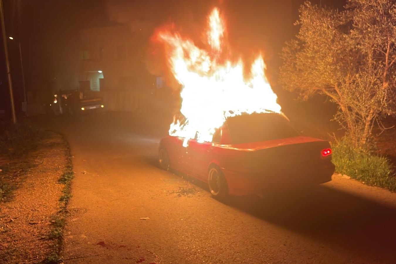 Israeli colonists set a vehicle ablaze during a raid into village near Ramallah