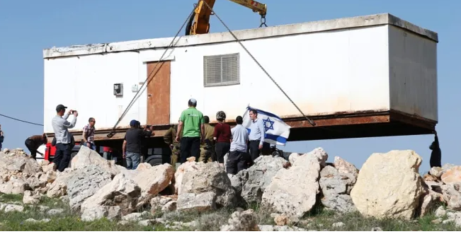 Israeli settlers install a caravan on a Palestinian land near Bethlehem 