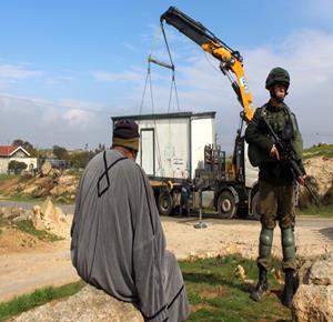 Israeli occupation forces seizing a Palestinian-owned structure in the West Bank. (File photo)